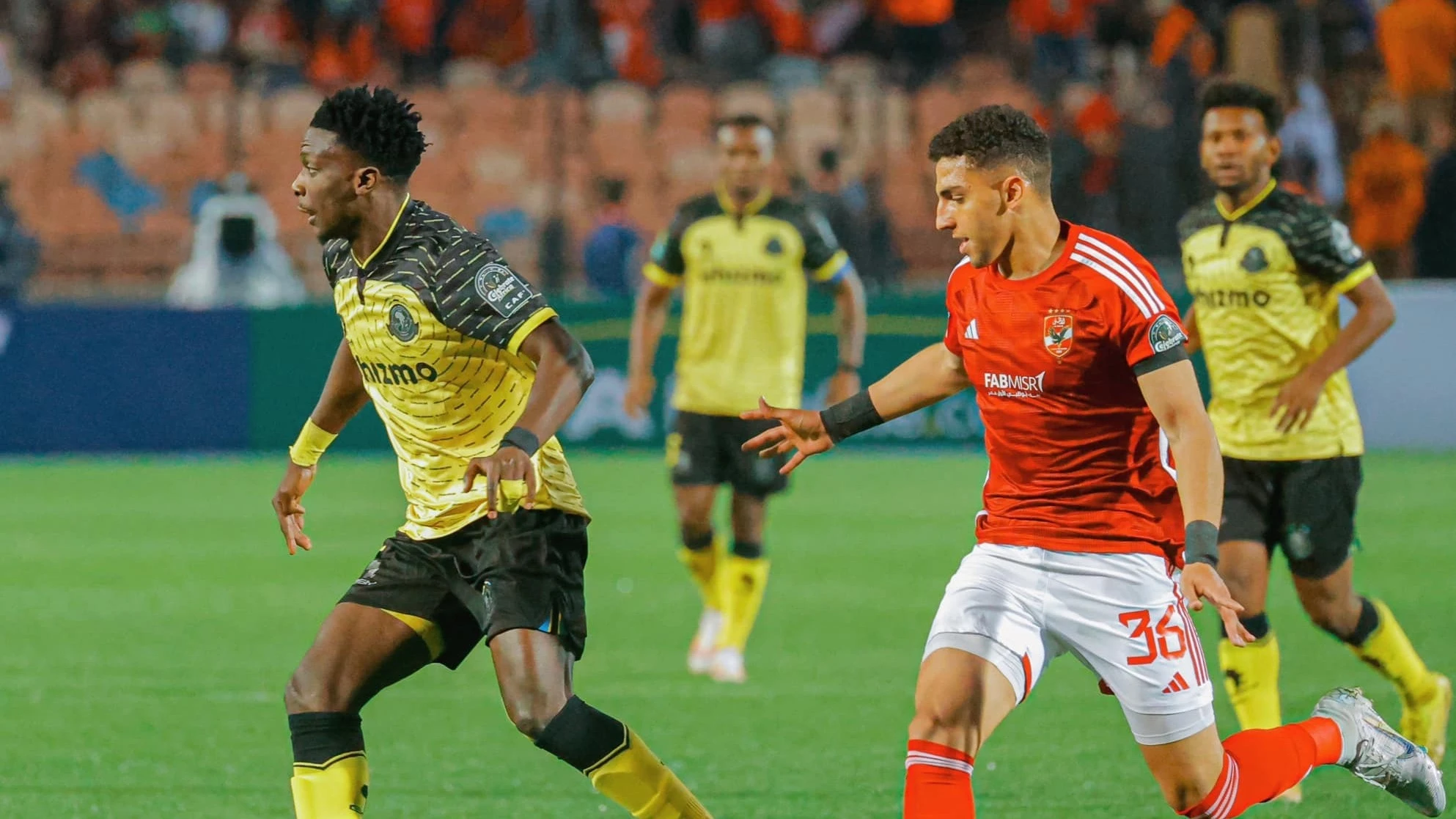 Yanga's attacker, Kennedy Musonda (L), attempts to get the better of Al Ahly midfielder Ahmed Nabil Koka. 