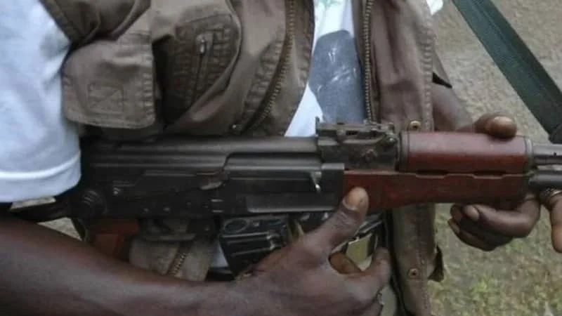 An unidentified man with a gun. 