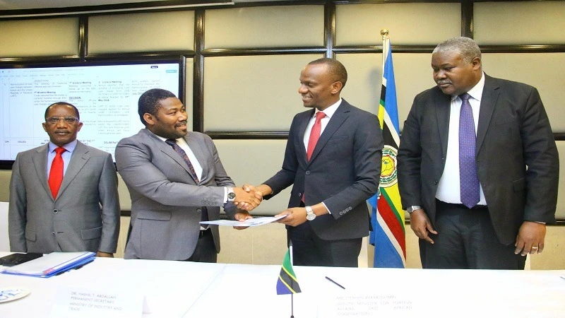 Deputy Minister of Foreign Affairs and East African Cooperation, Stephen Byabato ( 2nd R ) receiving the proposals for an agreement to remove non-tariff trade barriers between Kenya and Tanzania 