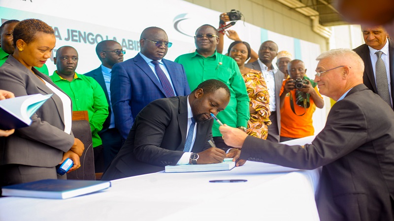Tanzania Airport Authority director general Mussa Mbura pictured in Mwanza city yesterday signing an agreement upon completion of the construction of a passenger building at the Mwanza International Airport.