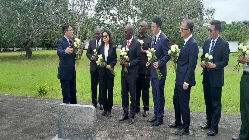 A protocol officer with the Chinese Embassy in Tanzania pictured in Dar es Salaam yesterday giving a brief history on one of the cemeteries where Chinese experts who died in Tanzania while engaged in the construction of the 1,860-km-long Tazara Railway.