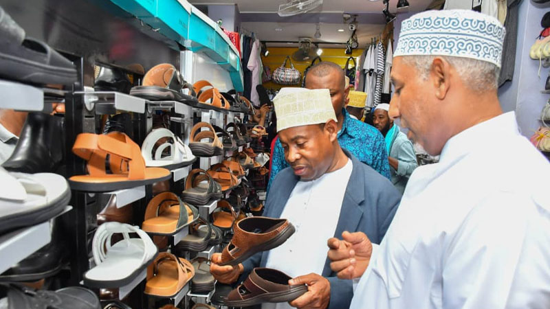 Zanzibar First Vice President Othman Masoud Othman Sharif checks shoes while going around shops along Zanzibar streets