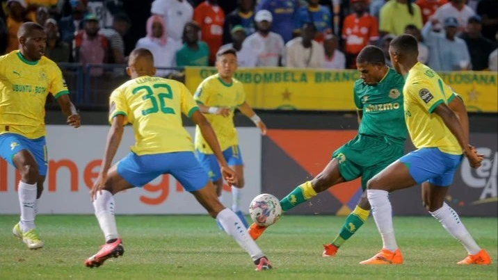 Yanga's Congolese midfielder, Maxi Nzengeli (2nd R,) attempts to get the better of Mamelodi Sundowns footballers when the teams locked horns in a 2023/24 CAF Champions League last eight's second leg in Pretoria last weekend.