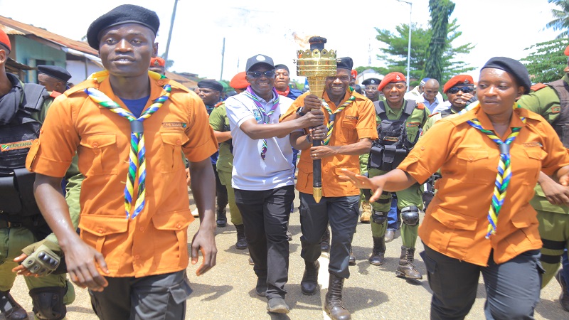 Uhuru Torch Race leader Godfrey Mnzava (R) and Korogwe District Commissioner William Mwakilema holding the torch leading the race to inspect development projects.