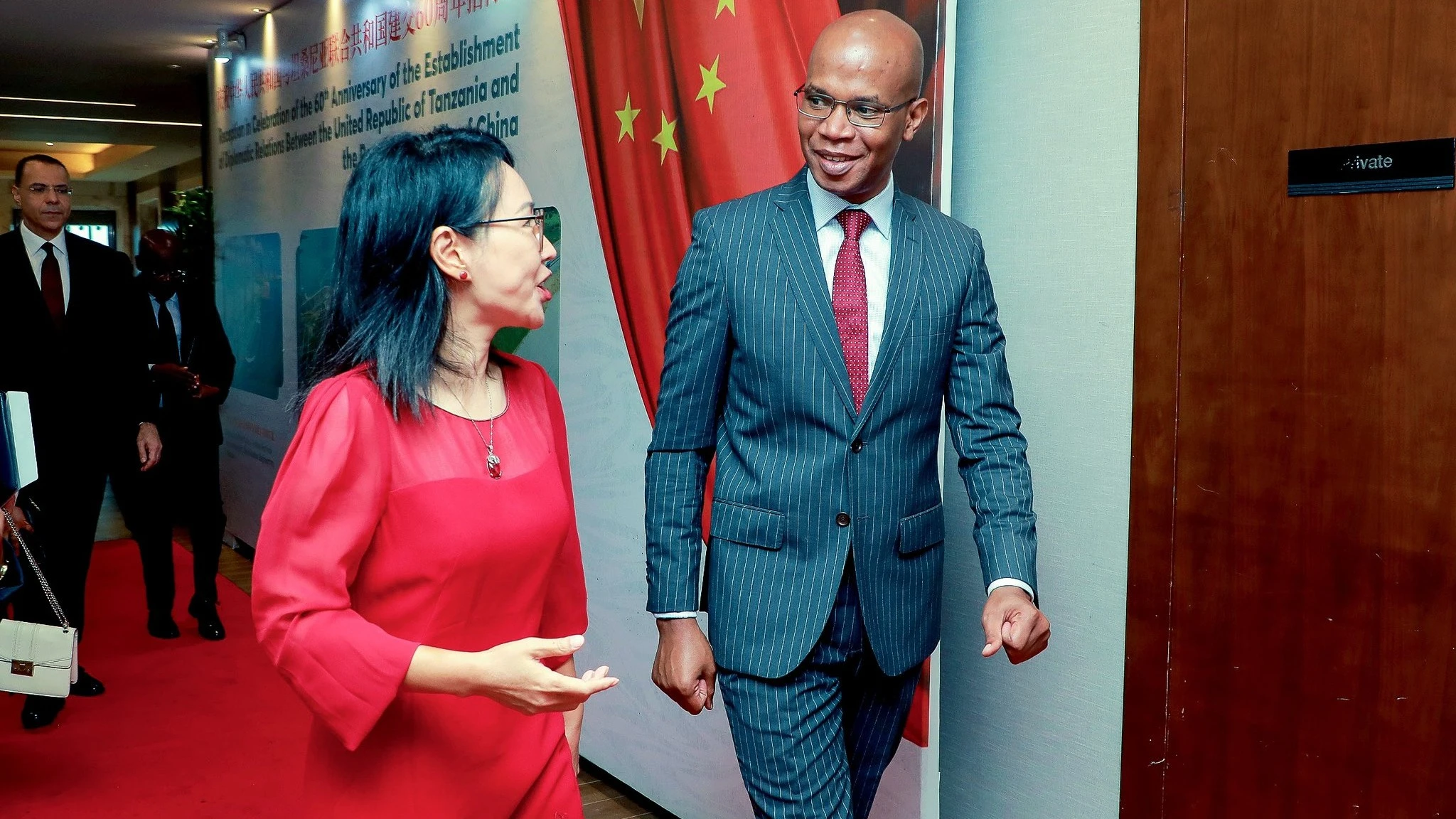 Minister for Foreign Affairs and East African Cooperation January Makamba shares a light moment with the Chinese Ambassador to Tanzania Chen Mingjian during the 60th anniversary of diplomatic relationship establishment of Tanzania and China 