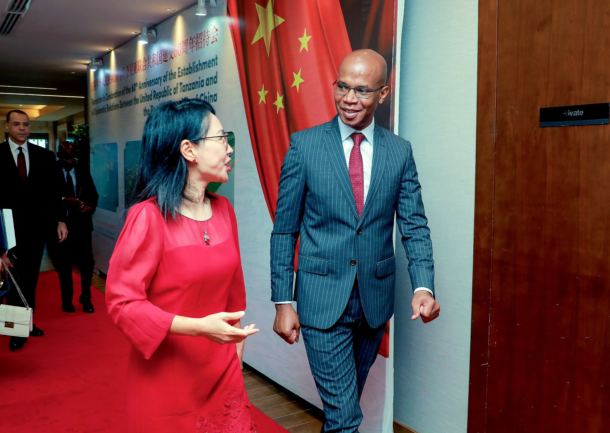 Chinese Ambassador Chen Mingjian (left) and Tanzanian Foreign Minister January Makamba share a quick chat en route to the 60th anniversary celebration of diplomatic ties between Tanzania and China in Dar es Salaam. 