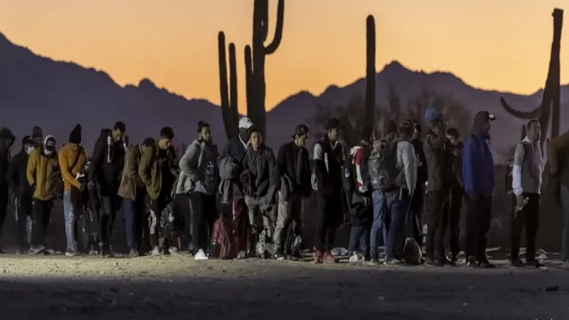Queue of migrants outside processing centre in Arizona after crossing the border.