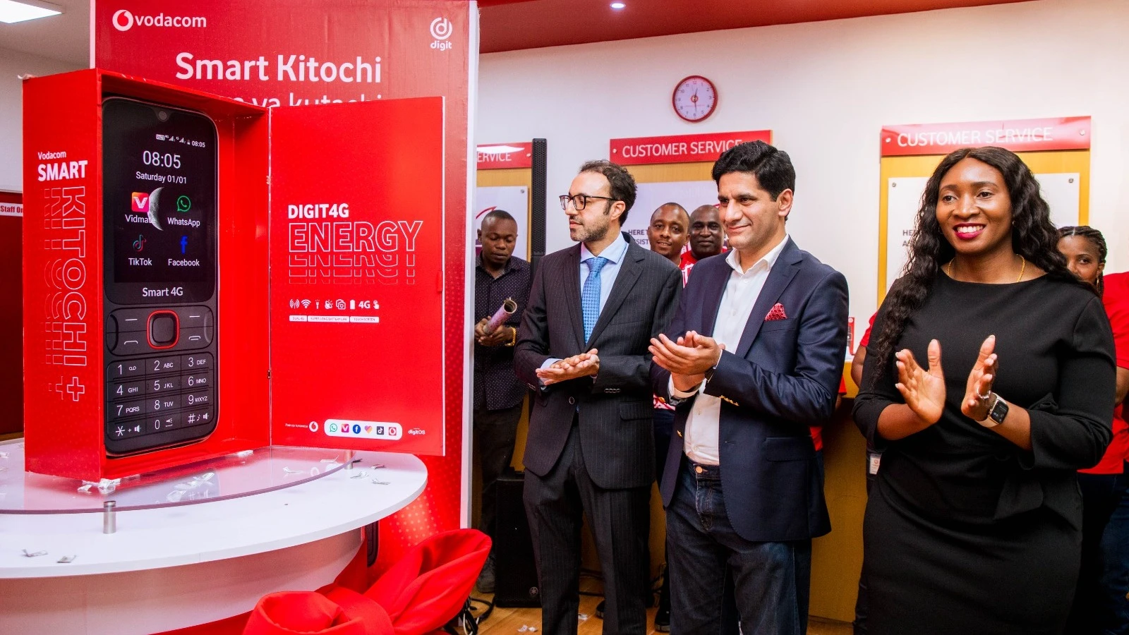 The Pakistan Ambassador to Tanzania, Siraj Ahmad Khan (left), the Chief Executive Officer of Digit Company, Abdul Rehman Mahmood, and the Director of Business at Vodacom Tanzania, Linda Riwa, applauding during the launch of a special phone.