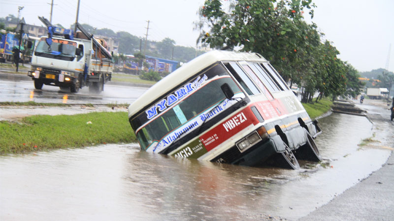 A commuter bus plying the Mbagala-Mbezi route in Dar es Salaam lies in a flooded ditch yesterday after skidding off the road at Temeke kwa Sokota, with sources saying several people were injured.