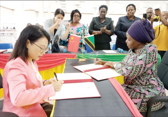 Community Development, Gender, Women and Special Groups minister Dr Dorothy Gwajima (R) and China’s Ambassador to Tanzania, Chen Mingjian, sign an agreement in Dar es Salaam yesterday 