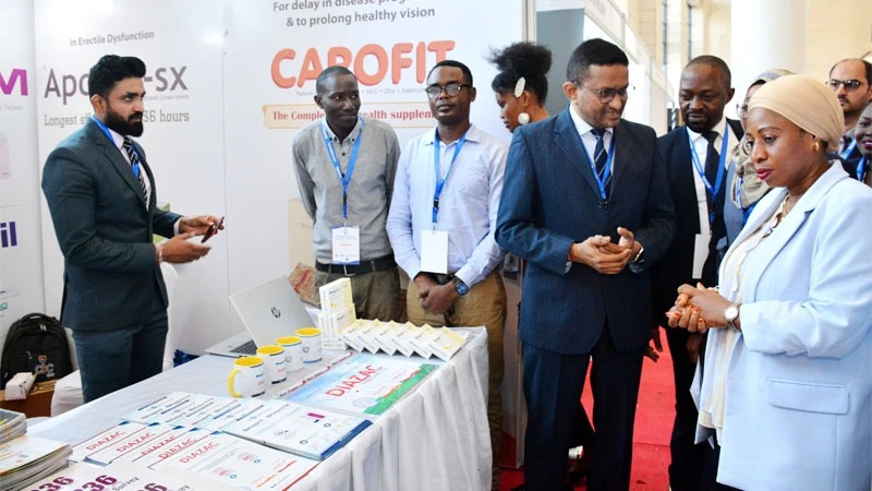 Health minister Ummy Mwalimu (R) visits a pavilion at an exhibition held in Dar es Salaam yesterday on the sidelines of the Association of Physicians of Tanzania’s annual general meeting. 