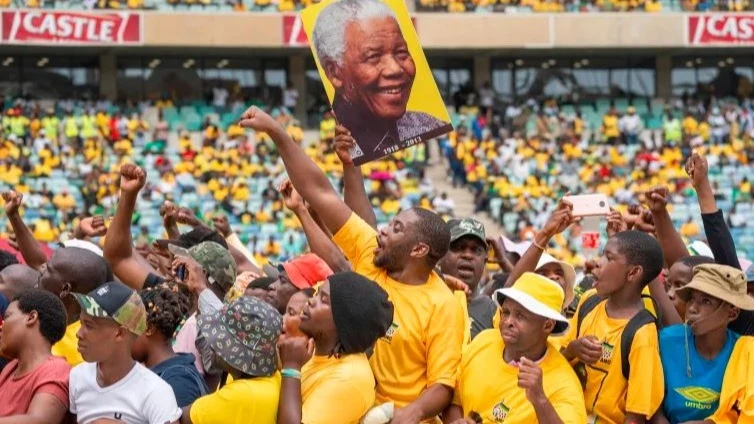 African National Congress supporters, one holding a portrait of Nelson Mandela, gather at a stadium in Durban, South Africa as the party launched its 2024 election manifesto 

 