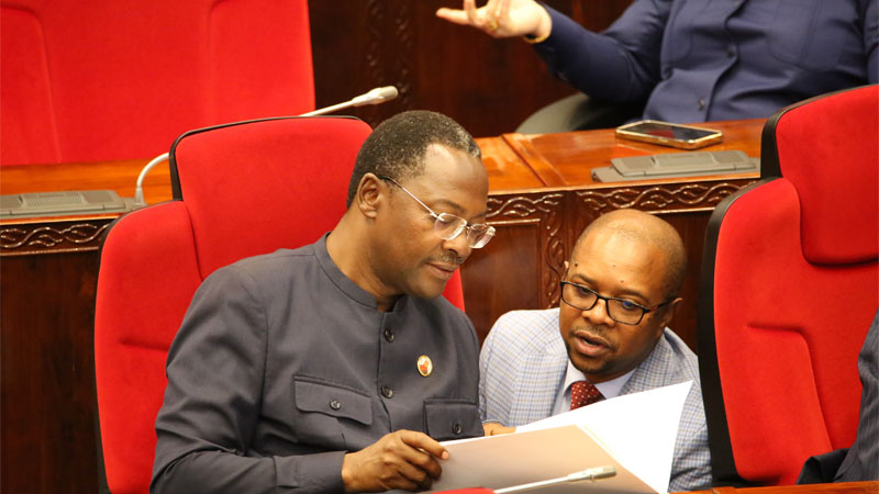 George Simbachawene (L), Minister of State in the President’s Office (Public Service Management and Good Governance), holds consultations with his deputy, Ridhiwani Kikwete, in the National Assembly debating chamber in Dodoma city yesterday. 