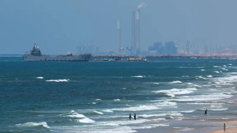 
A military vessel was seen on Thursday in the sea next to pier that will be used to bring aid ashore to Gaza.