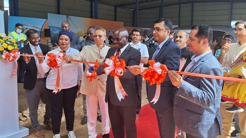 Deputy Minister of Industry and Trade, Exaud Kigahe (C) cuts a ribbon to officially launch the Fortune Cement Plant in Mkuranga District Coast Region over the weekend.