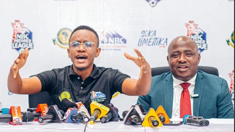 Young Africans SC’s Information and Communications Manager, Ally Kamwe (L) addressing the press regarding the team's preparations for the ceremony of receiving the NBC Premier League championship trophy from the main sponsor, NBC Bank. 