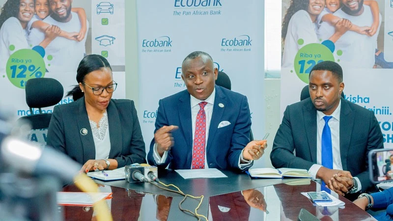 Ecobank Tanzania Managing Director, Dr. Charles Asiedu (C) addresses the audience at the launch of a new lending solution for civil servants, alongside the bank's senior officials