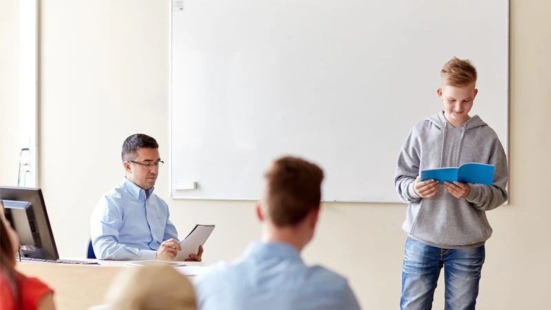 Students leaning in the classroom