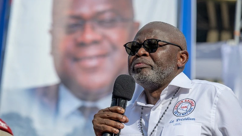 DRC's Minister of Economy Vital Kamerhe, addresses supporters of the Union sacrée (Sacred Union), the new majority governing coalition in the country's National Assembly of gathering at The Martyrs Stadium in Kinshasa on April 29, 2023. 