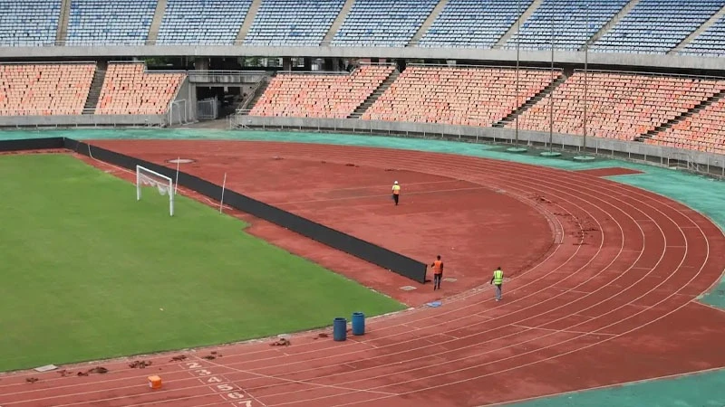 Workers taking a break after working on the running tracks for athletes. 