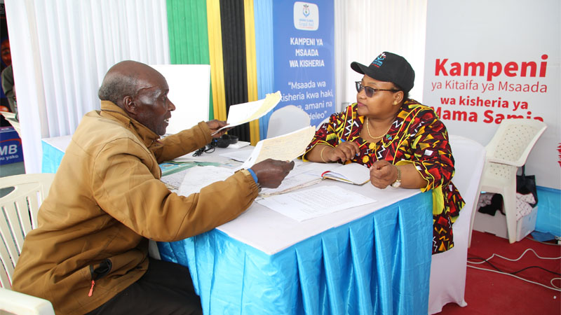 Constitution and Legal Affairs minister Dr Pindi Chana (R) pictured yesterday hosting Njombe town resident Hieronymus Mswata (81), who was seeking legal assistance. 