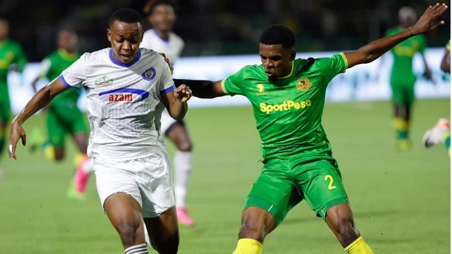 Azam FC midfielder Feisal Salum (L) negotiates his way past Young Africans SC defender Ibrahim Hamad (Bacca) during their Federation Cup final match at the New Amaan Complex in Zanzibar on Sunday.