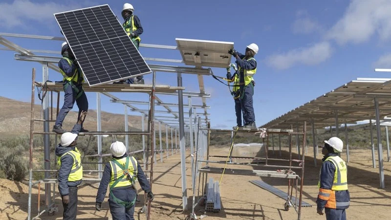 Energy technicians at work installing solar panels.