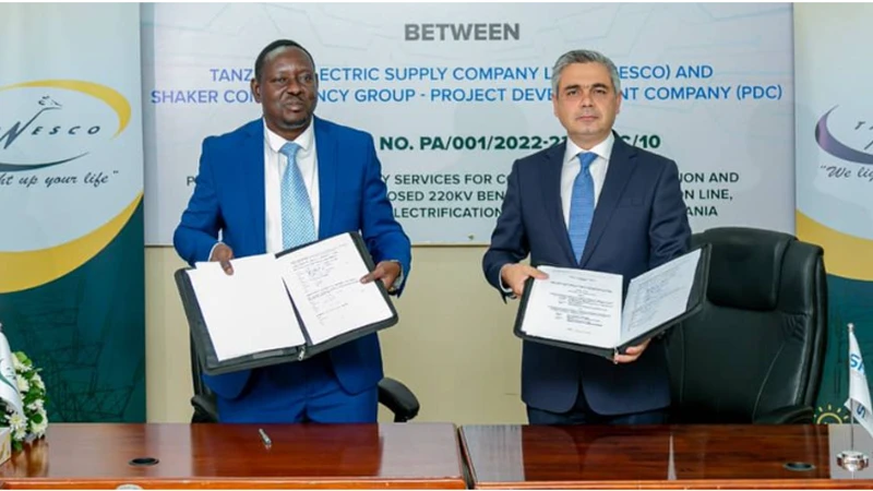 The CEO of Tanesco (left), Gissima Nyamo-Hanga and the Chief Executive Officer of Shaker Consultancy Group, Dr. Ismail Shaker showing the contracts they signed.