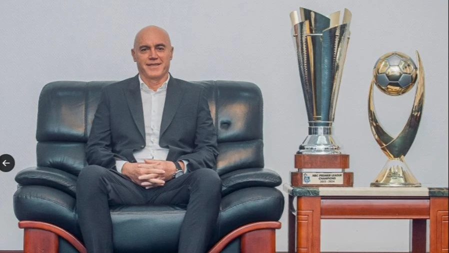 Young Africans head coach Miguel Gamondi with the Premier League and Federation Cup trophies won by the Jangwani Street-based side in the just-ended 2023/24 season.