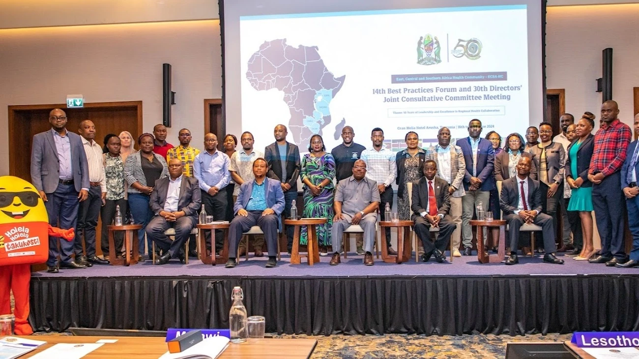 Participants of the 14th Best Practices Forum and the 30th Directors Joint Consultative Committee (DJCC) Meeting in a group after witnessing the presentation of the “Holela-Holela Itakukosti” a social behavioral change multimedia campaign 