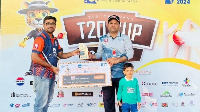 Jatin Darji of Flashnet Strikers (R) receives the Ras Logistics Man of the Match prize from Caravans Cricket Club's Secretary, Nandu GN, after the completion of the 2024 Petrofuel TCA Caravans T20 Cup tie pitting the club versus Azania Bank Pak Stars rece