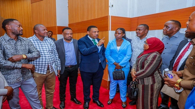 Finance minister Dr Mwigulu Nchemba (4th-L) and his Industry and Trade counterpart, Dr Ashatu Kijaji (in head-cloth), have a word with representatives of members of the business community in Dar es Salaam’s sprawling Kariakoo market zone yesterday.