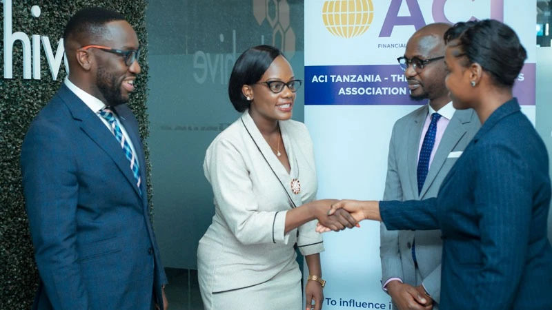ACI FMA Tanzania President, Naomi Mafwiri (left), shakes hands with ACI FMA Tanzania Secretary, Catherine Mwita (right), in Dar es Salaam shortly after the meeting which discussed the achievements of the association over the 100 days