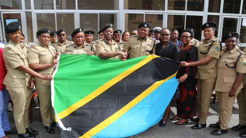 Tanzania Police Force Commissioner of Operations and Training CP Awadh Haji (5th R) hands over the National Flag to 58 women police officers in Dar es Salaam yesterday, 
