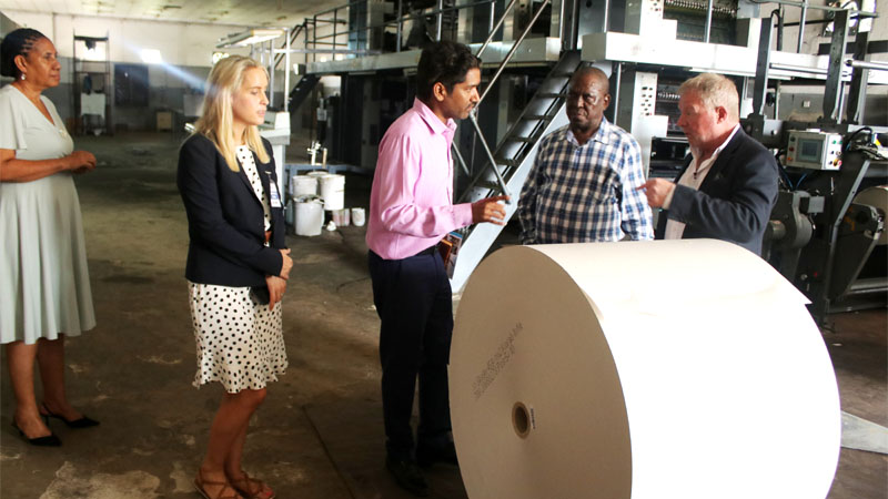 The Guardian Ltd (TGL) publishers of The Guardian and Nipashe newspapers Commercial Director, Ajay Goyal (C) explains a point on the printing press production to Helium One Global Ltd Financial and Commercial Director, Graham Jacobs (R) during their visit