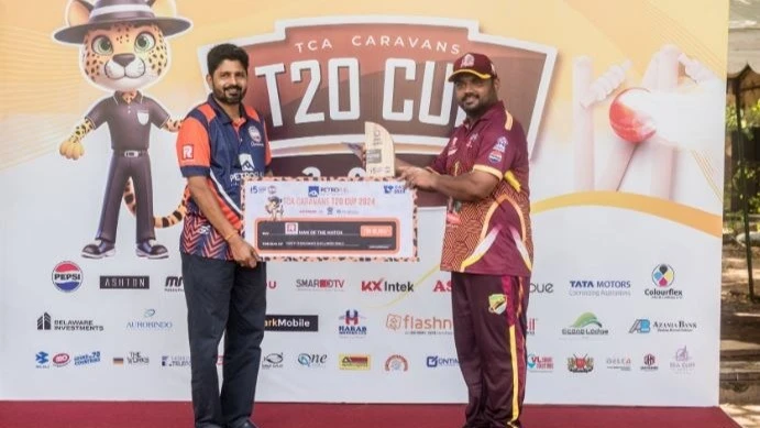 Balakrishna Foundation Aces' cricketer Ankit Baghel (R) receives the Ras Logistics Man of the Match prize from Caravans Cricket Club's Chairman, T. G. Thulaseedas, following the player's outfit's win over Azania Bank Pak Stars