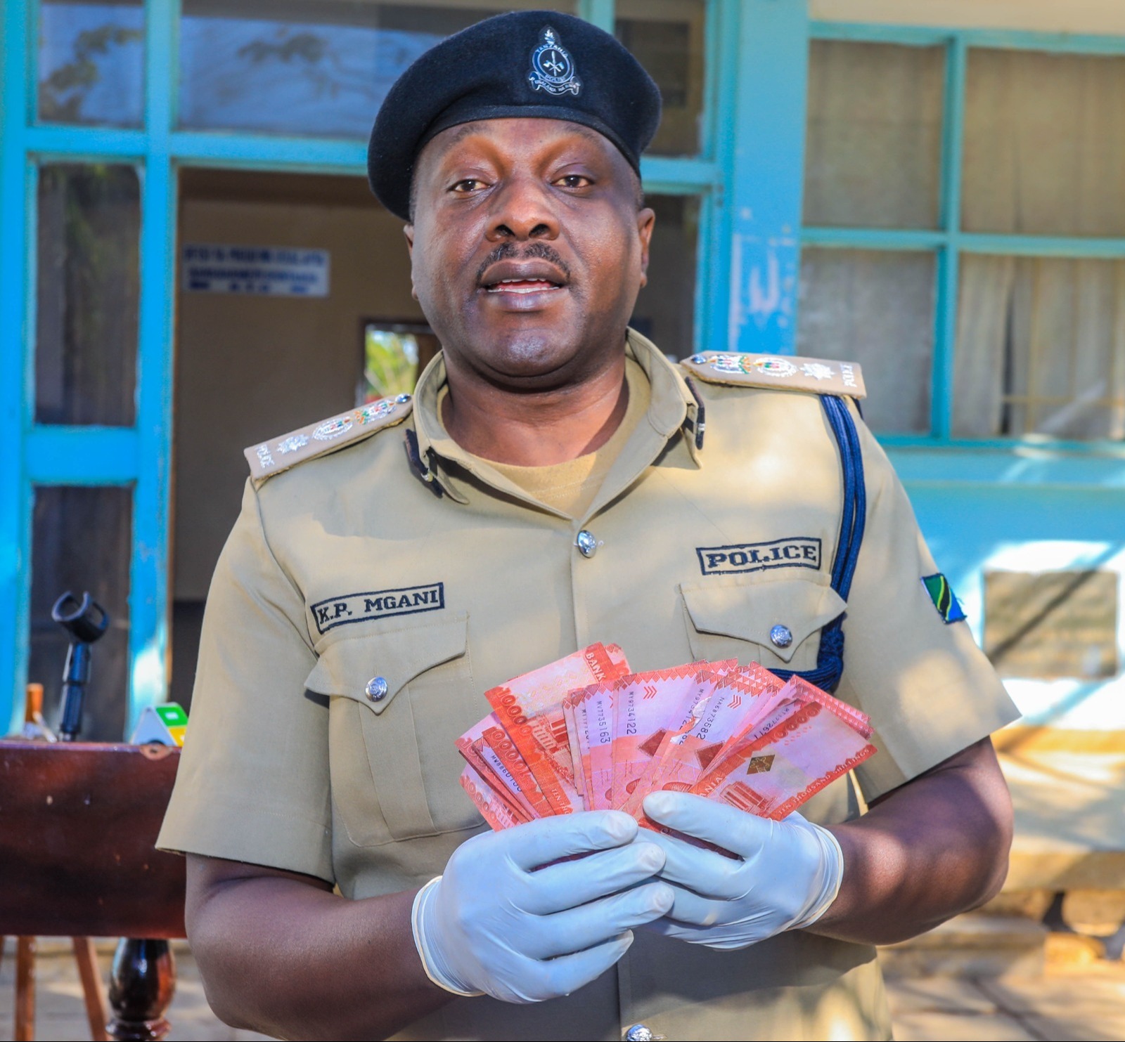 Shinyanga acting Regional Police Commander Kennedy Mgani shows journalists in Shinyanga municipality on Wednesday what he said were fake 10,000/- banknotes with a street value totalling 420,000/- 