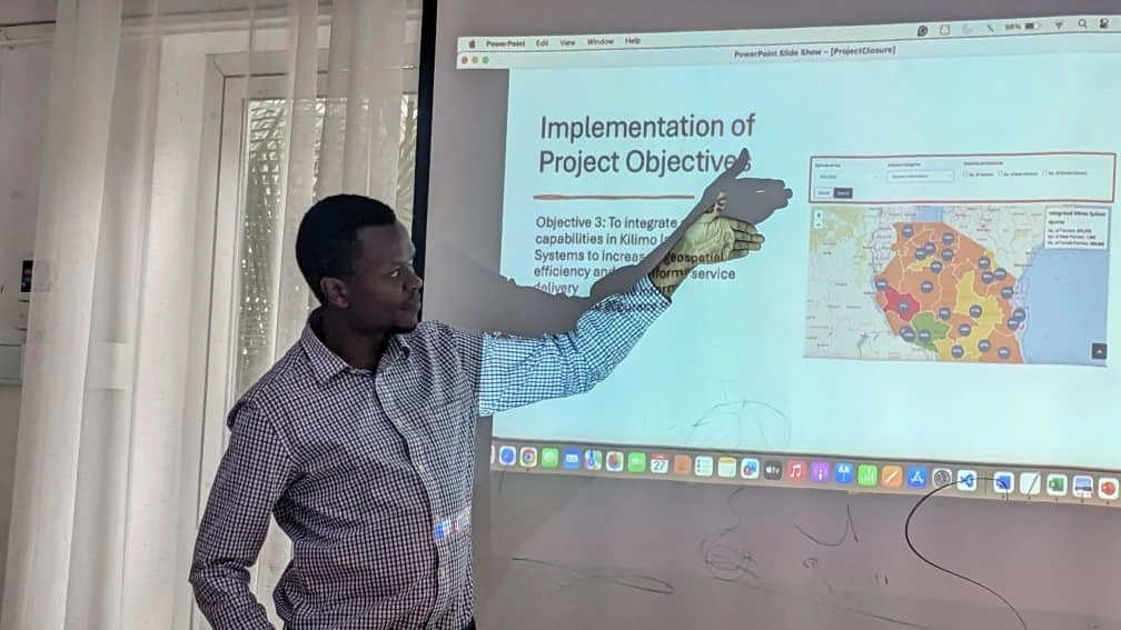 Anthony Kigombora, an ICT expert from a consulting firm on digital agricultural system  explains the use of the Digital Agriculture Information Systems dashboard at the handover event in Arusha.