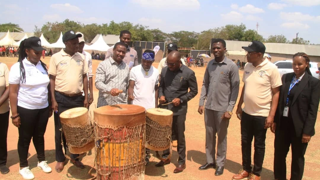 Deputy Minister for Natural Resources and Tourism, Dunstan Kitandula (third left) and Bariadi District Commissioner Simon Simalenga (centre) drum during the launch of the Lake Zone Cultural and Tourism Festival at Bariadi CCM Stadium in Simiyu Region.