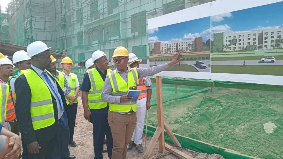 Dr. Fredrick Salukele (1st – L), Director of Vocational Training at the Ministry of Education, Science, and Technology, listens to Saimon Moshi, the Epitome site engineer, as he explains a building project at NIT supported by the WB Eastrip project.
