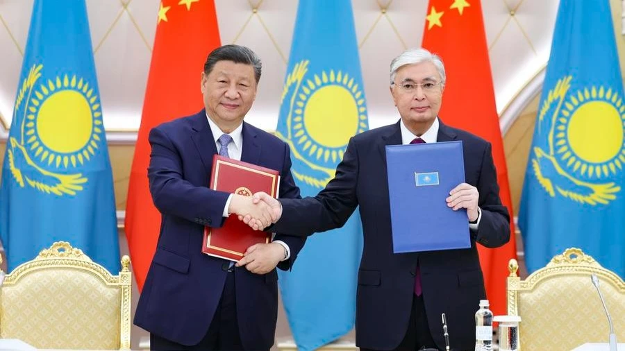 Chinese President Xi Jinping and Kazakh President Kassym-Jomart Tokayev sign the joint statement between the People's Republic of China and the Republic of Kazakhstan, and witness the exchange of dozens of bilateral cooperation documents in the fields