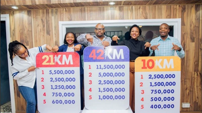 
Officials from the organizers, Brendansia Kileo (2nd R) and Esnat Holella (2nd L), and media partners, including Eddo Kumwembe (C), Oscar Oscar (R), and Adela Tillya (L), showcasing the cash prizes 