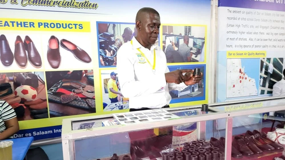 Abdul Lwangisa, DIT Spare Parts Factory manager showcases a rubber boot made by DIT Spare Parts company  at the on-going 48th  Dar es Salaam International Trade Fair (DITF)