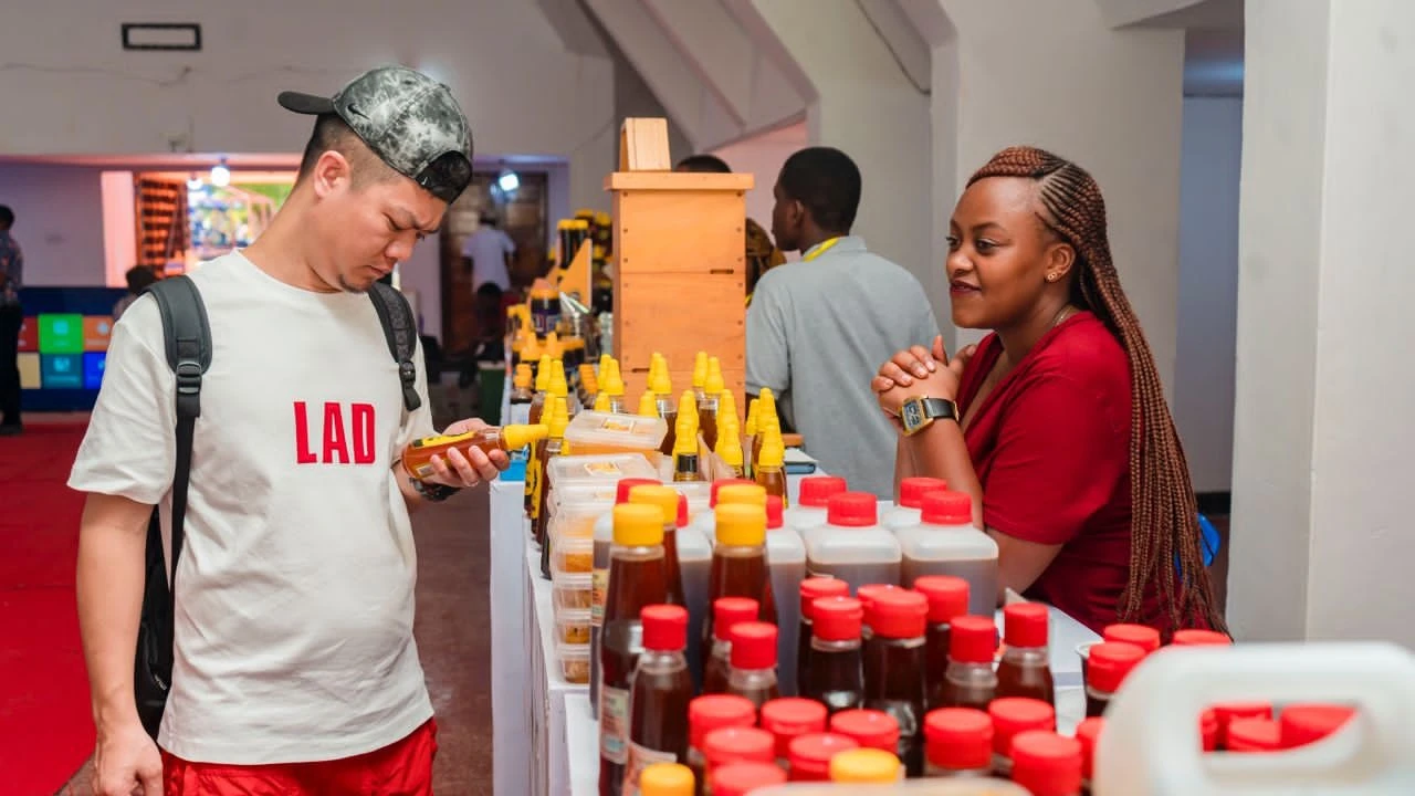  

A customer admires honey at the BEVAC pavilion at the ongoing 48th Dar es Salaam International Trade Fair (DIFT 2024) .