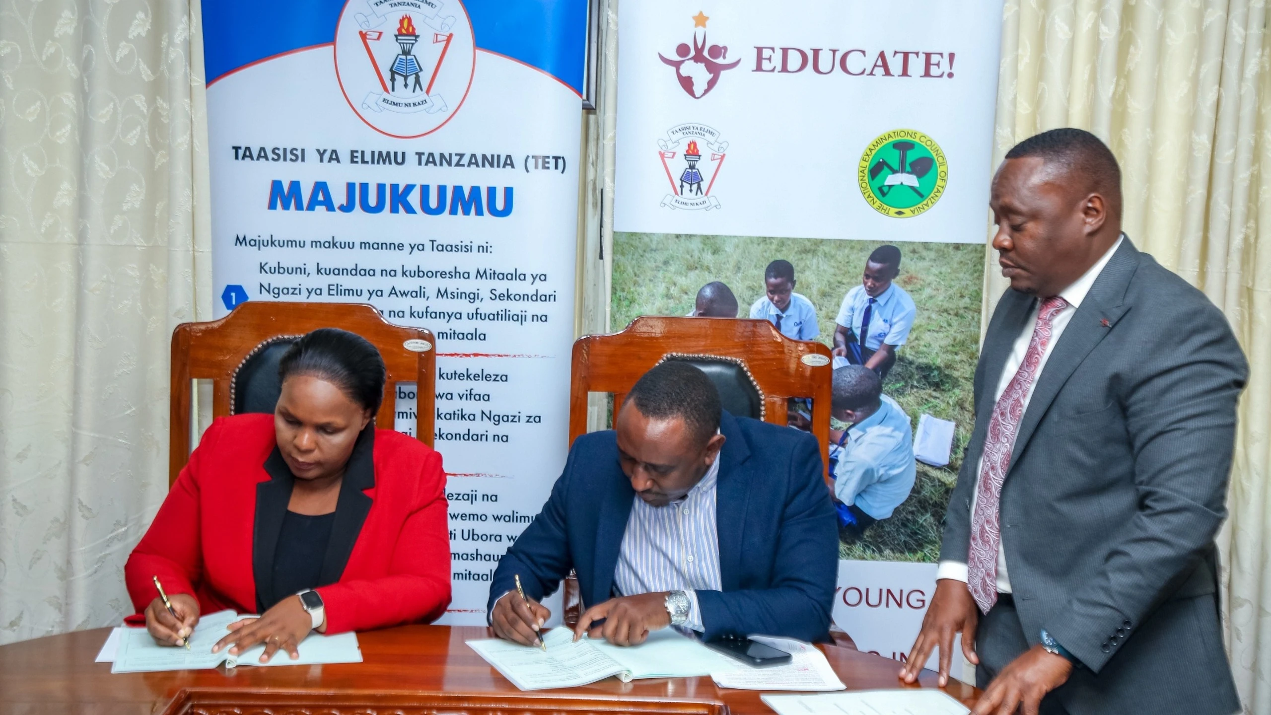 Tanzania Institute of Education director Dr Aneth Komba (L) and Educate Institute director Kamanda Kamiri pictured in Dar es Salaam yesterday signing an agreement aimed at promoting and providing continuous training in the teaching of business subjects.