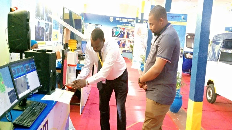 Eng Afidhu Yusufu, Senior Instructor at the Dar es Salaam Institute of Technology (DIT) explains to a visitor on how the fruit fly automatic detection and monitoring system works at the on-going 48th Dar es Salaam International Trade Fair. 