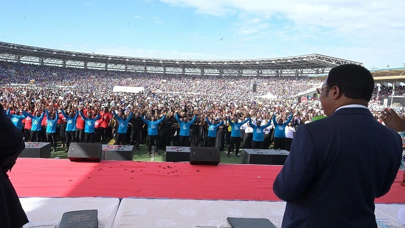 Prime Minister Kassim Majaliwa follows one of songs of praise and worship sung at celebrations held at national level at Uhuru Stadium in Dar es Salaam yesterday to mark the 85th Anniversary of the Tanzania Assemblies of God (TAG) Church