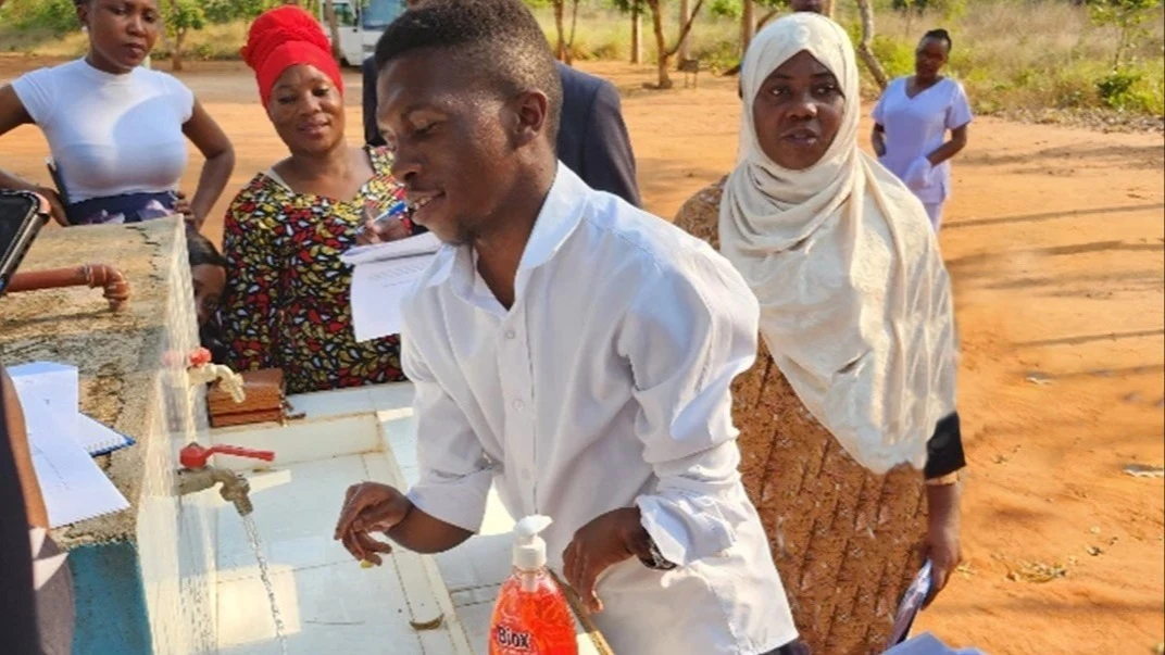 Training participants test accessibility and useability of hand washing facilities at a public primary school in Pwani region. 