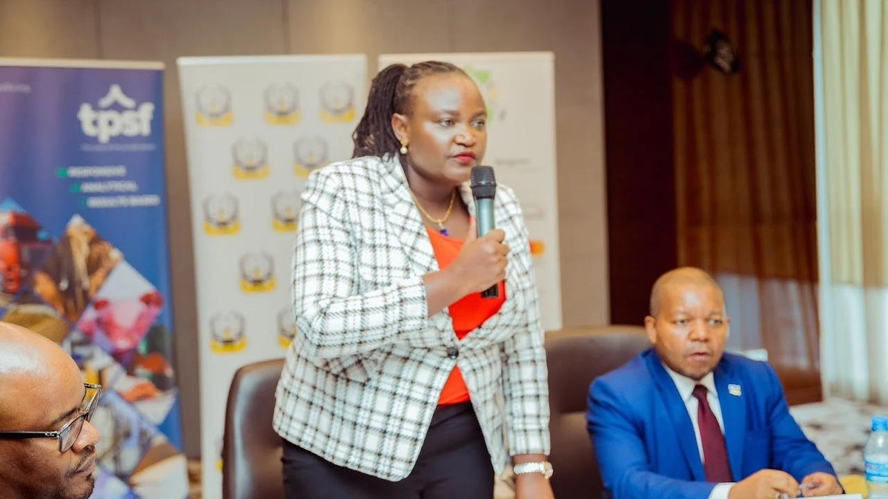 Tanzania Private Sector Foundation(TPSF) (centre) addressing the representatives of private organisations.TRA commissioner general(right)  listens.