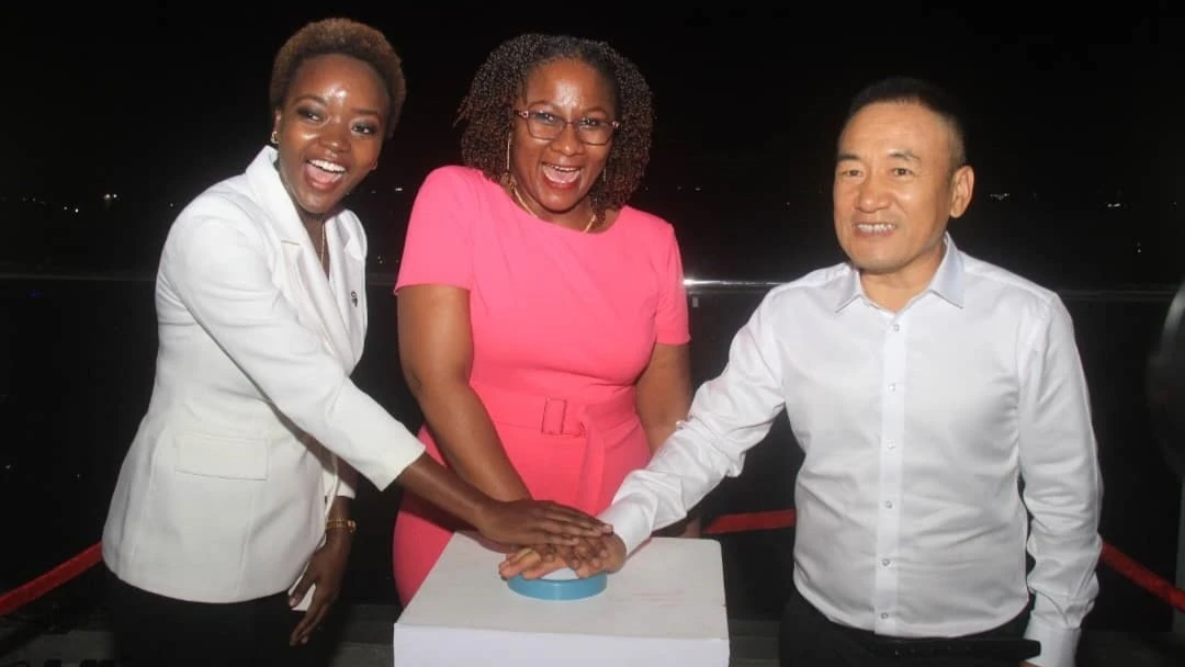 Director for Real Estate at the Ministry of Lands, Housing and Human Settlement Development, Dr. Upendo Matotola (C), the TT Investments Limited Director, Yongjun Liu (R) pressing the button during the official launch of the Phoenix Condo project
